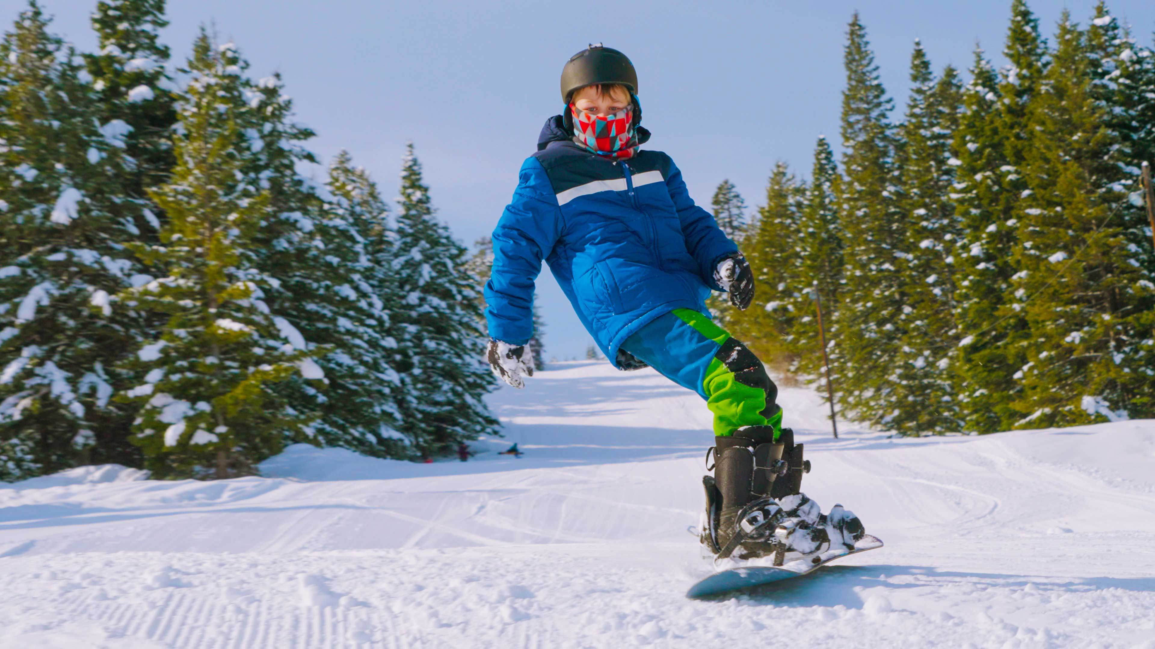 Young snowboarder descends Cottonwood Butte Ski Area's impressive 845 ft. of vert. 